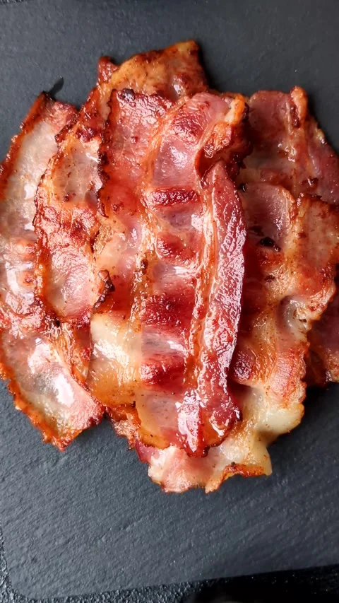 Fried fresh bacon slices with layers of meat or prosciutto with salt and spices. Stock-Footage 335377984