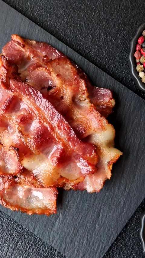 Fried fresh bacon slices with layers of meat or prosciutto with salt and spices. Stock-Footage 335377987