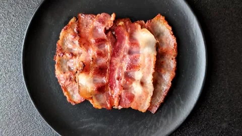 Fried fresh bacon slices with layers of meat or prosciutto with salt and spices. Stock-Footage 335377989