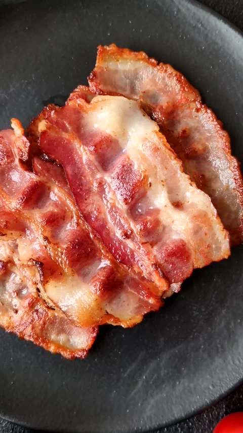 Fried fresh bacon slices with layers of meat or prosciutto with salt and spices. Stock-Footage 335378020