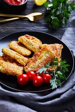 Fried fresh cod fillet with cherry tomatoes Stock Photos