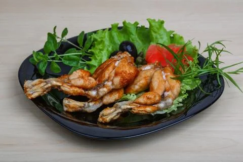 Fried frog legs Stock Photos