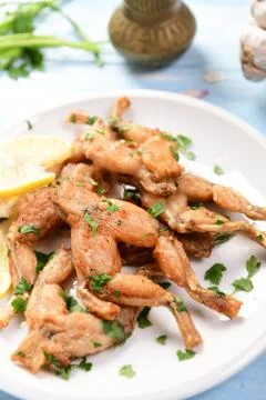 Fried frog legs Stock Photos