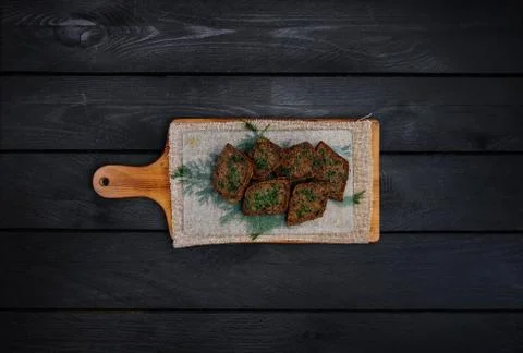 Fried garlic croutons, black bread with dill. On a wooden board. Top view. Bl Stock Photos
