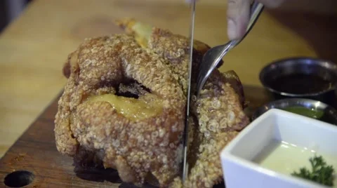 Fried German pork knuckle (eisbein) sliced with knife closeup time-lapse Stock Footage 63351097