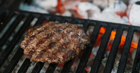 Fried grilled cotlet for burger cooked on coals, grill. Beef steak meat. Stock Footage 136074860