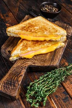 Fried ham and melted cheese sandwich. Dark wooden background. Top view Stock Photos