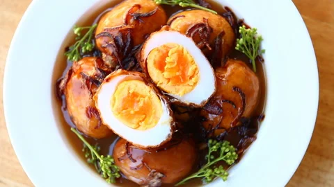 Fried hard boiled eggs in tamarind sauce or Kai Lug  Kuey , Thai famous food Stock Footage 145706852