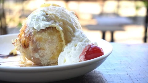 Fried ice cream with red cherry and chocolate served on white plate. Stock Footage 123471947