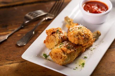 Fried lamb chops in parmesan batter with tomato sauce Stock Photos