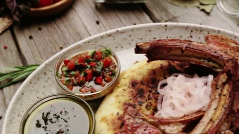 Fried lamb ribs on pita bread with onion and sauce. Stock-Footage 80992757