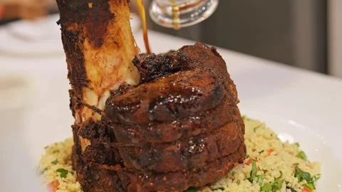 Fried leg, generously poured with sauce. Watch as the savory sauce flows over Stock Footage 273323086