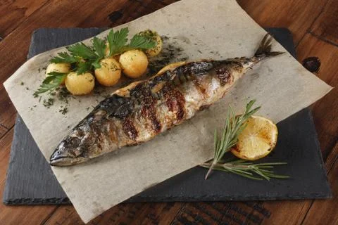 Fried mackerel fish stuffed with lemon. Stock Photos