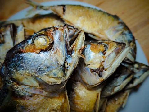 Fried mackerel is placed on top of each other on a plate. Stock Photos