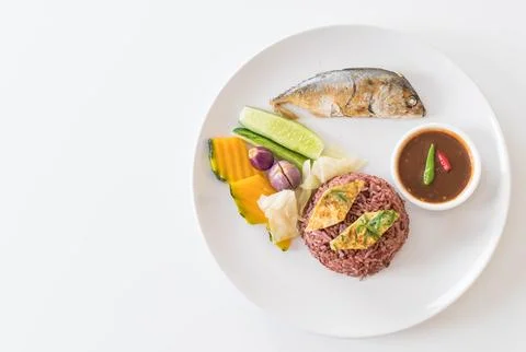 Fried mackerel with shrimp paste sauce and berry rice Stock Photos