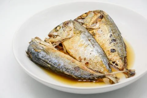 Fried mackerel on white plate. Deep fried fish Stock Photos
