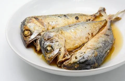 Fried mackerel on white plate. Deep fried fish Stock Photos