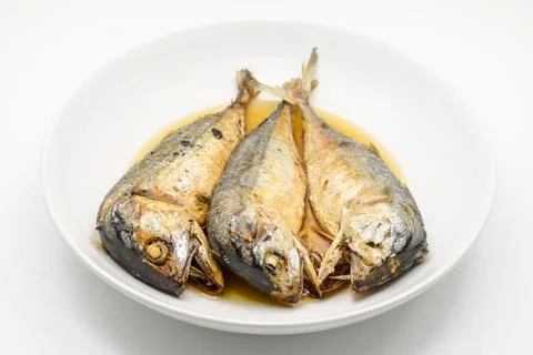 Fried mackerel on white plate. Deep fried fish Stock Photos