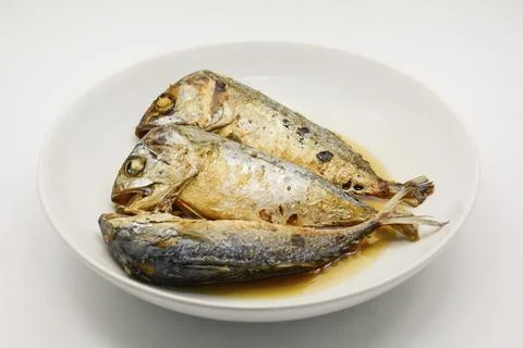 Fried mackerel on white plate. Deep fried fish Stock Photos