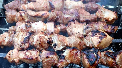 Fried meat on the coal with smoke Stock Footage 122990060