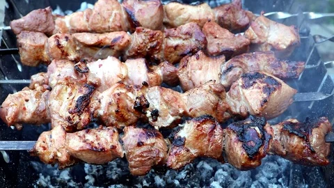 Fried meat on the coal with smoke Stock Footage 122990067