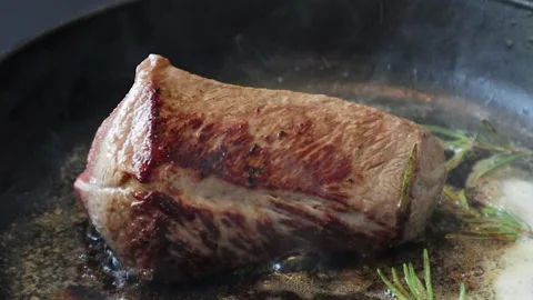 Fried meat is cooked in a frying pan 库存影片 200203831