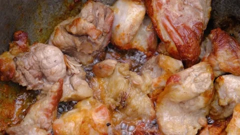 Fried meat with crust. Meat in a cauldron. Eastern cuisine Stock Footage 204855750