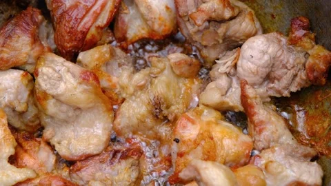 Fried meat with crust. Meat in a cauldron. Eastern cuisine Stock Footage 208935806
