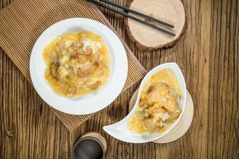 Fried meat with egg corn sauce in rustic bowls Stock-Fotos
