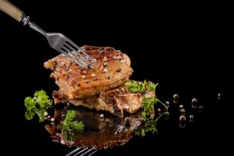 Fried meat on the fork with pepper Stock Photos