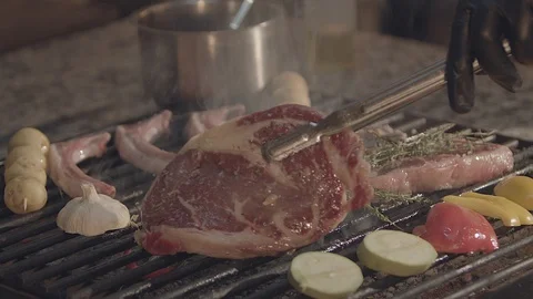 Fried meat on the grill. Chef's cooking Video stock 100780913
