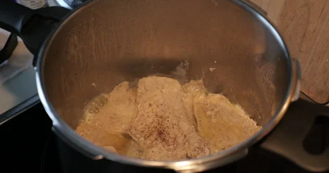 Fried meat in high stainless pan 4K video Stock Footage 299983347