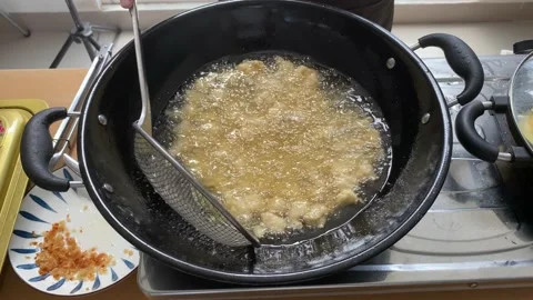 Fried meat or flour in a pan. boiling oil Stock Footage 227698194