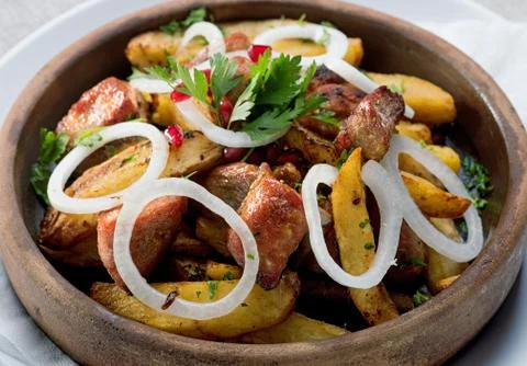 Fried meat in potatoes Stock Photos