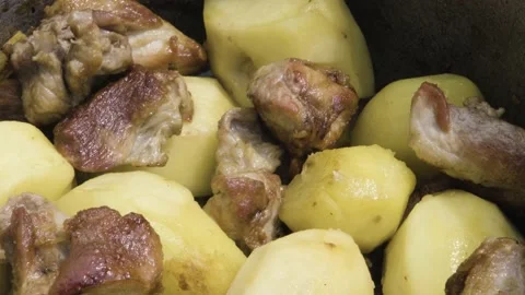 Fried meat with potatoes in the process of cooking. Meat is stewed with potatoes Stock-Footage 211088381
