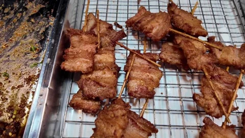 Fried Meat Skewers on Wire Rack at Street Food Market Video stock 343763917