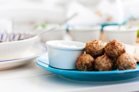 Fried meatballs with white sauce and flat cakes - traditional Greek lunch on  Stock Photos