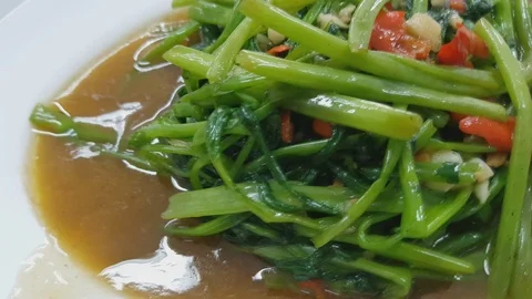 Fried morning glory in a plate on the table Stock Footage 100545971