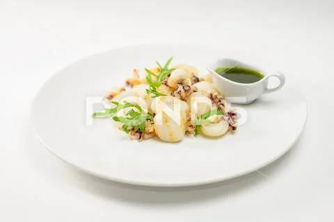 Fried octopus and pine with green sauce Stock Photos