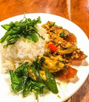 Fried one-thousand-year egg with crispy holy basil leaves and rice Stock Photos