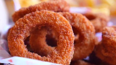 Fried onion rings made in a busy kitchen Stock Footage 325013391