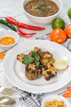Fried oxtail served on a table with lemon slices. Foto stock