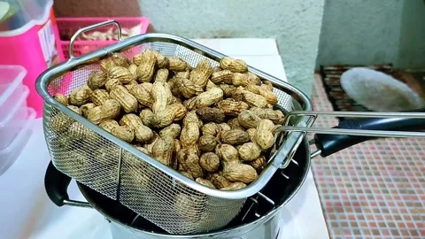 Fried peanuts in a metal strainer Stock Footage 337128258