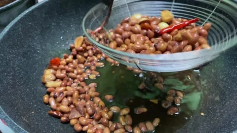 Fried peanuts. This is the stage for making pecel or gado-gado sauce, which is 스톡 동영상 328471861
