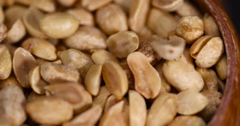 Fried peeled peanut kernels in a wooden bowl, fried yellow peanuts with a little Stock Footage 311345137