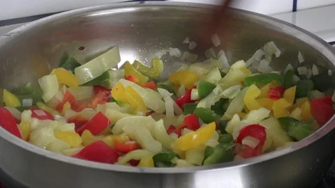 Fried pepper on a frying pan. Fried colorful vegetables on a frying pan. Stock Footage 92090230