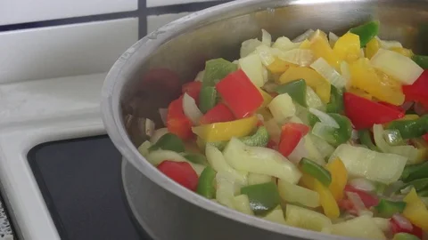 Fried pepper on a frying pan. Fried colorful vegetables on a frying pan. 스톡 동영상 92194469