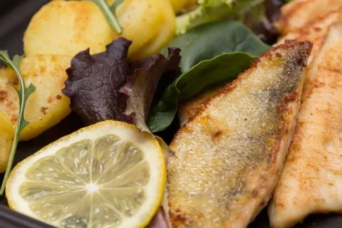 Fried perch filets with potatoes Stock Photos