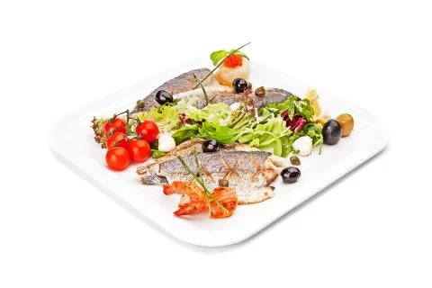 Fried pieces of fish, served by vegetable &amp; shrimps. Stock Photos