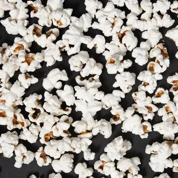 Fried popcorn on a black background close-up, ready-to-eat food 스톡 사진